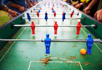 Playing, foosball and people outdoor with table, game or closeup on competition with ping pong...