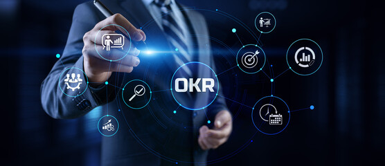 OKR Objectives key results. Businessman pressing button on screen.