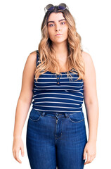 Fototapeta premium Young caucasian woman wearing casual clothes and sunglasses with serious expression on face. simple and natural looking at the camera.