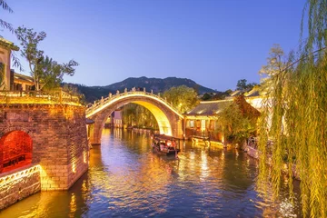 Foto op Aluminium Beautiful bridge and river in the ancient Chinese village of Gubei Water Town with reflections in water at blue hour, Gubeikou, Miyun, Simatai, Beijing, China © Revive Photo Media