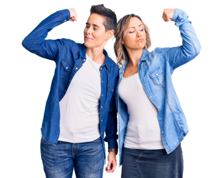 Couple of women wearing casual clothes showing arms muscles smiling proud. fitness concept.