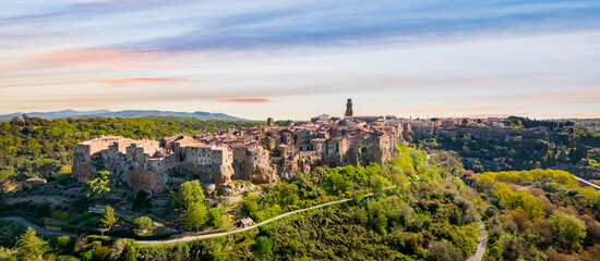 Panoramic aerial view of Pitigliano town in Tuscany, Italy. Typical etruscan town with the houses on the border of the tuff rocks. - 689023175