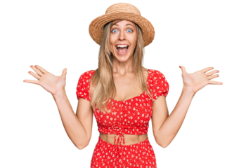 Beautiful caucasian woman wearing summer hat celebrating crazy and amazed for success with arms raised and open eyes screaming excited. winner concept