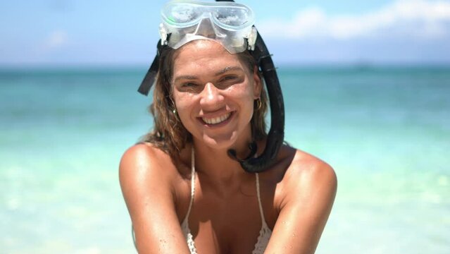 Happy, face and woman with mask for scuba diving, adventure and blowing a kiss on holiday or vacation. Funny, portrait or snorkeling at tropical, sea or travel in ocean with gear or pouting in nature