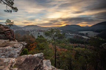 Hilly landscape shot on a sandstone rock in the forest. Cold morning mood at sunrise at a...