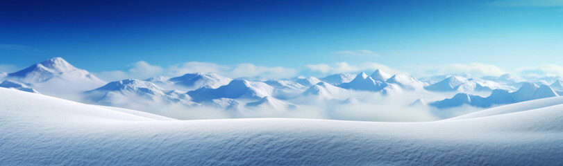 Snow covered mountaintops with a blue sky above banner background.