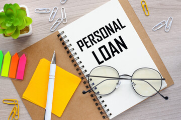 Personal Loan symbol. glasses lie on a notepad. text on the page. bright stickers