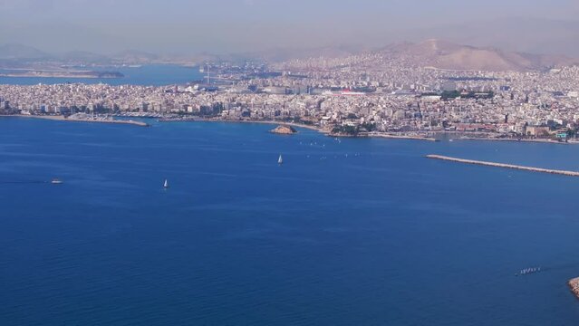 Aerial slider shot over the Aegean sea and Athens city