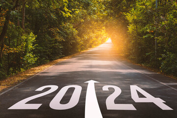 The new year 2024 or straightforward concept. Text 2024 written on the long road in the forest. planning and challenge, business strategy, opportunity, hope, and new life.	 - obrazy, fototapety, plakaty
