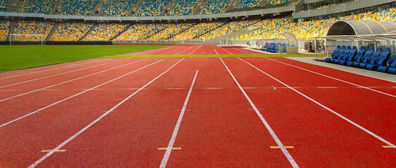 Red running track in a sports stadium. Sports boarder.	