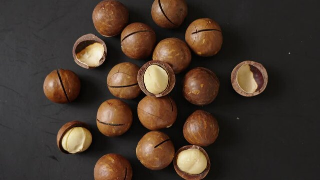 Close up macadamia nuts on black background.