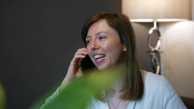 A happy shocked and surprised young woman receiving good news and congratulating a friend talking in the phone