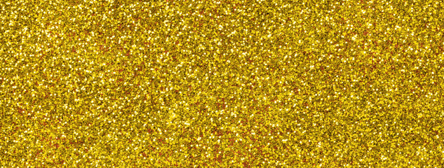 Abstract golden sparkling shiny background from small sequins, macro. Glitter yellow backdrop