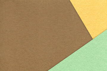 Texture of craft brown color paper background with light yellow and green border. Vintage abstract umber cardboard.