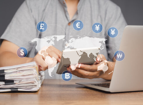 A businessman uses a calculator to calculate currency exchange.