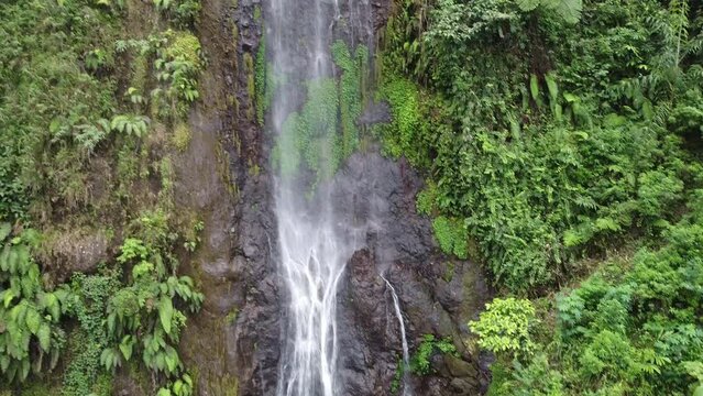 beautiful waterfall in indonesia taken from drone