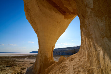  Natural arch on the Tuzbair salt marsh. Natural arch at Tuzbair is a natural formation carved by erosion.Salt marsh Tuzbair is one of the most famous attractions of the Mangystau region of Kazakhstan