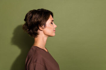 Fototapeta premium Side profile photo of peaceful relaxed girl with bob hairstyle dressed brown t-shirt keep eyes closed isolated on khaki color background