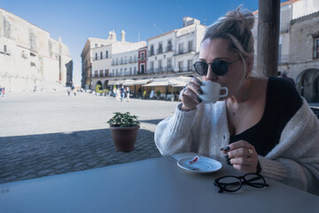 Woman Enjoys Coffee, Absorbing Plaza Energy
