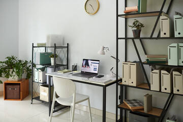 Home office of businessman with desk and bookcases