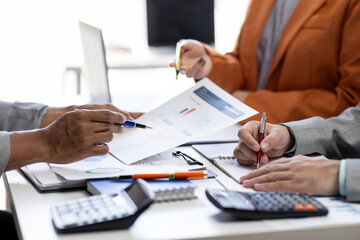 Close up Team of colleagues discussing business Accounting using calculating income-expenditure and calculator analyzing real estate investment data report Financial and tax systems concept.
