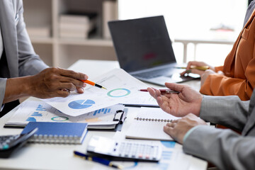 Close up Team of colleagues discussing business Accounting using calculating income-expenditure and calculator analyzing real estate investment data report Financial and tax systems concept.