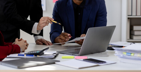 Close up Team of colleagues discussing business Accounting using calculating income-expenditure and calculator analyzing real estate investment data report Financial and tax systems concept.