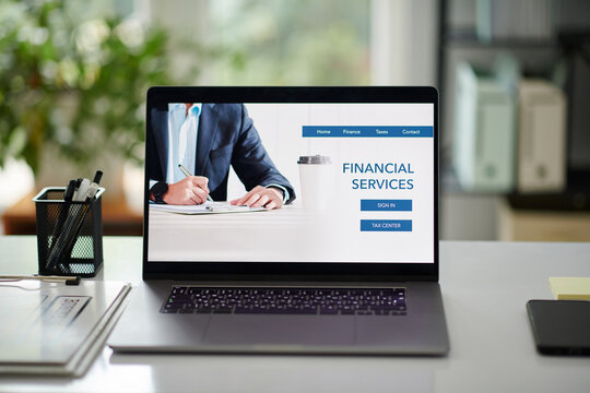 Financial services for business people, laptop with website on screen on office desk