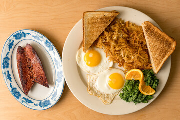 fried eggs, hash browns, sausage and toast