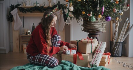 Woman Decorating Christmas Tree Preparing For Christmas Holidays