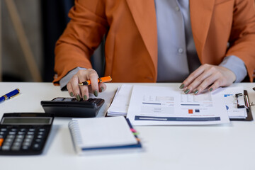 Fototapeta premium Business woman working at office with documents on his desk, doing planning analyzing the financial report, business plan investment, finance analysis concept 