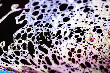 Beautiful psychedelic abstraction formed by light on the surface of a soap bubble
