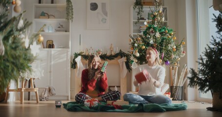 Smiling Female Friends Preparing Christmas Gifts For Xmas Holidays