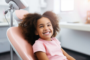 Little African American girl sits on dental chair. Professional kids stomatology. Teeth healthcare - obrazy, fototapety, plakaty