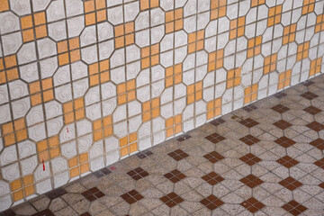 Vintage 1960s to 1980s mosaic tiles with geometrical square design on the wall and floor of an...
