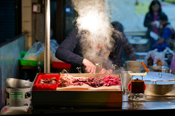 Naklejka premium Head in the steam at night market in Taipei