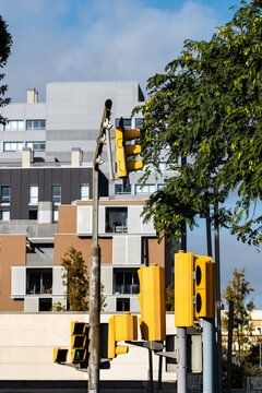 Abstract Cityscape: Yellow traffic lights punctuate the scene against a backdrop of sleek modern buildings. An abstract urban portrait blending vibrant signals with contemporary architecture.