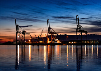 Fototapeta na wymiar Blue hour by the industrial harbour of Malaga