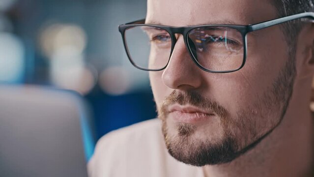 Close up shot of man eyeglasses reflection showing stock market graphic. Confident business analytic learning crypto markets industry. Shares investor analyzing charts