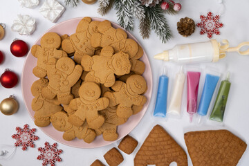 Christmas gingerbread in the shape of men and a set of colored sugar icing for decoration