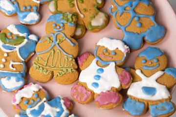 Christmas gingerbread in the shape of men decorated with colorful icing, top view