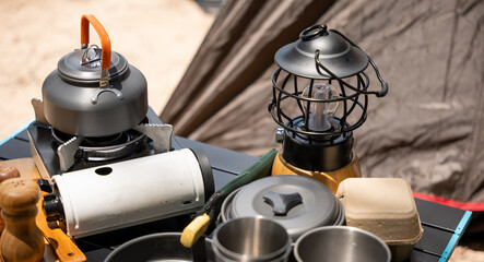 Cooking gear for a tranquil beach campsite, kettle, pot, pan, gas stove, flashlight, and camera set...