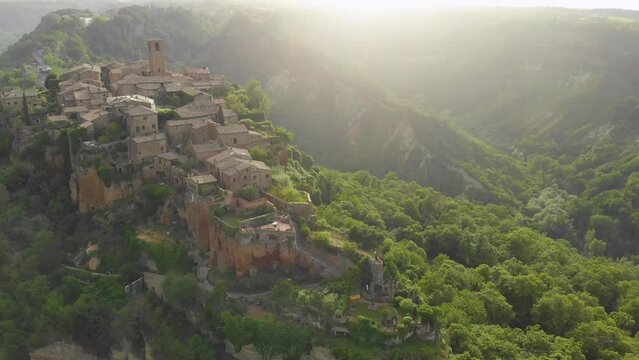 Aerial summer evening view of famous Civita di Bagnoregio town, beautiful place located on top of a volcanic tuff hill overlooking the Tiber river valley. The place has Etruscan and Medieval origins.