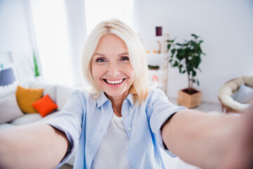 Self portrait of beautiful blonde hair cheerful business woman wearing blue shirt recording new...