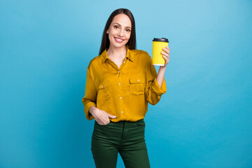 Photo of positive good mood woman dressed yellow shirt enjoying coffee to go isolated blue color background