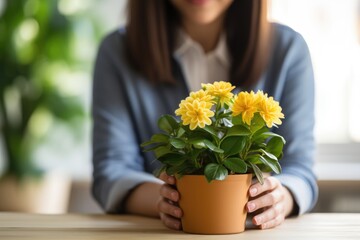 Woman holding vase with beautiful flowers in table. Closeup.