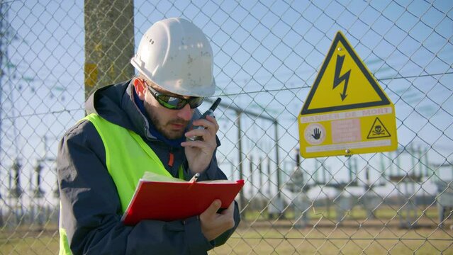 Employee reporting findings of electrical installation inspection on radio