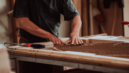 A skilled worker in the woodworking industry adeptly utilizes modern machinery to process and prepare wooden doors for the market, showcasing a seamless blend of traditional craftsmanship and cutting