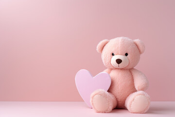 Obraz premium Pink teddy bear with lilac heart on a pink background