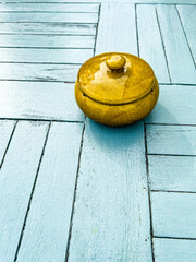 A Ceramic Pot On A Wooden Blue Painted Table
